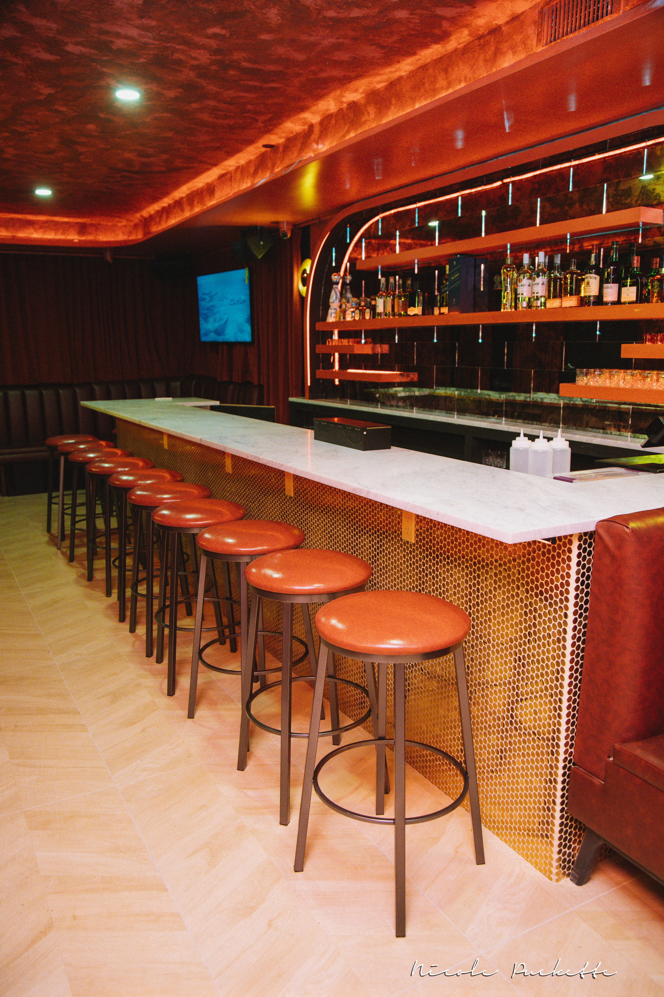 The Red Room bar at Partake NYC — copper, marble and red neon