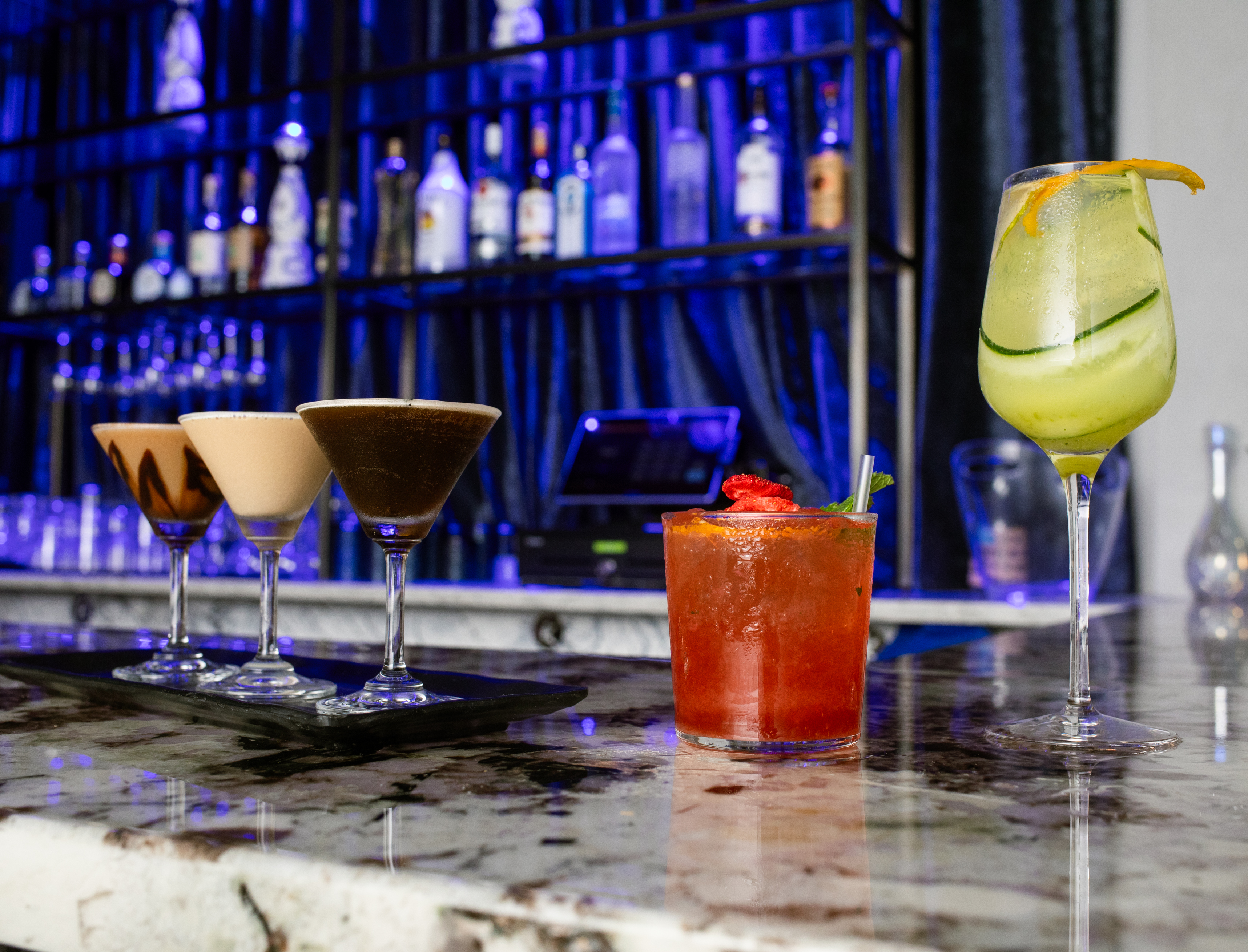A cocktail flight on the marble bar at Partake NYC