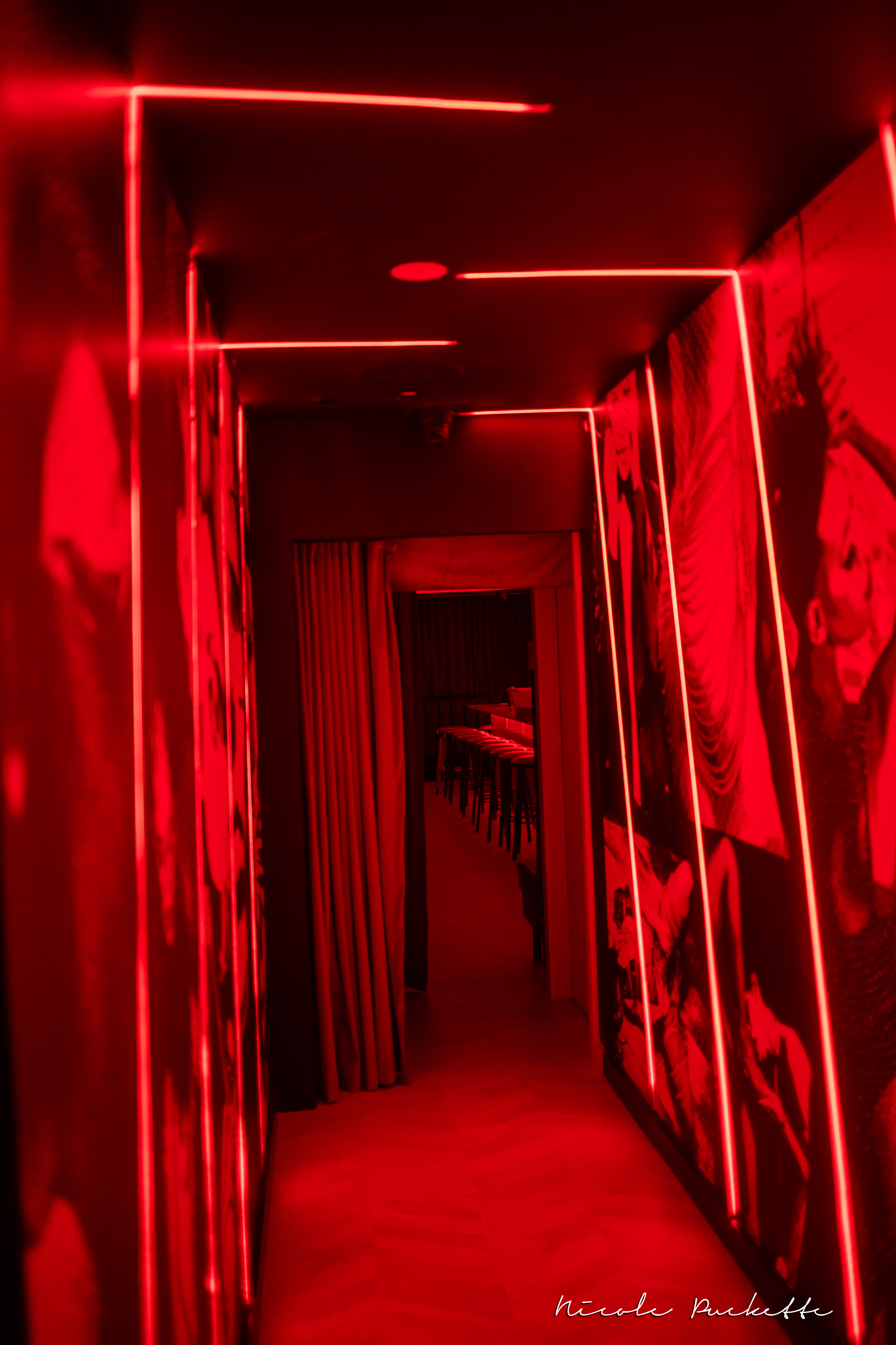 The red-lit hallway leading to the Red Room at Partake NYC